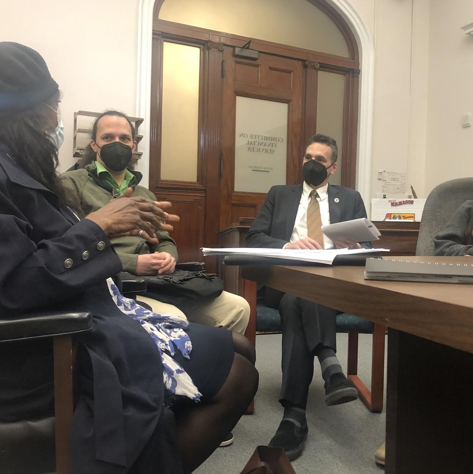 three people meeting in a room